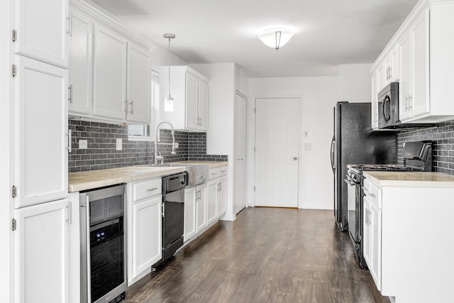 169 Waterbury Cir, Oswego, IL 60543 - kitchen featuring stainless steel appliances, wine cooler, light countertops, a sink, and tasteful backsplash