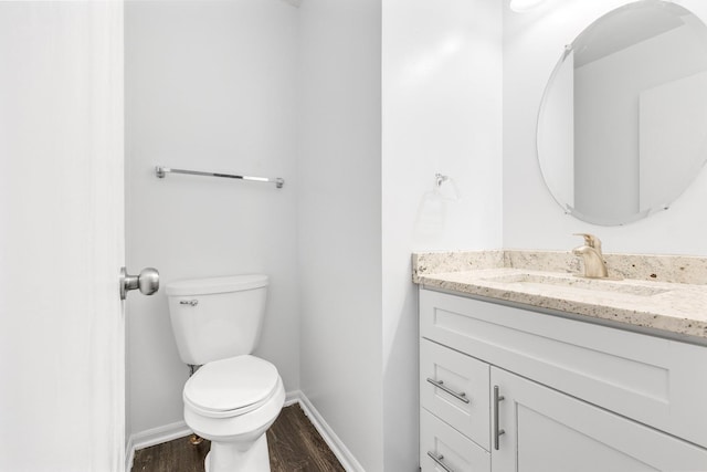169 Waterbury Cir, Oswego, IL 60543 - bathroom featuring wood finished floors, vanity, toilet, and baseboards