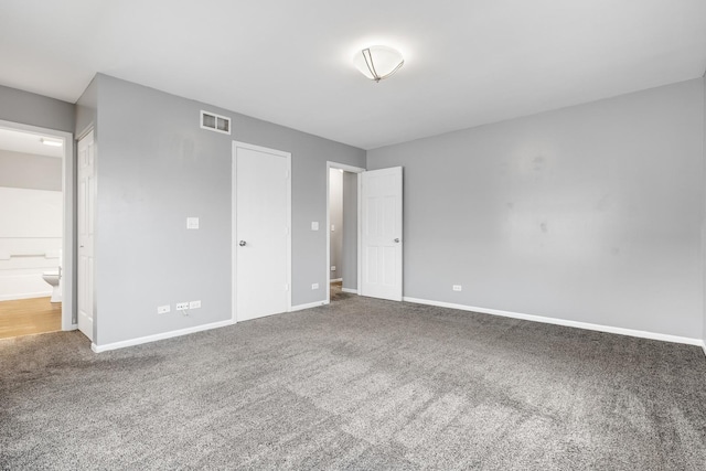 169 Waterbury Cir, Oswego, IL 60543 - unfurnished bedroom featuring carpet floors, visible vents, baseboards, and connected bathroom