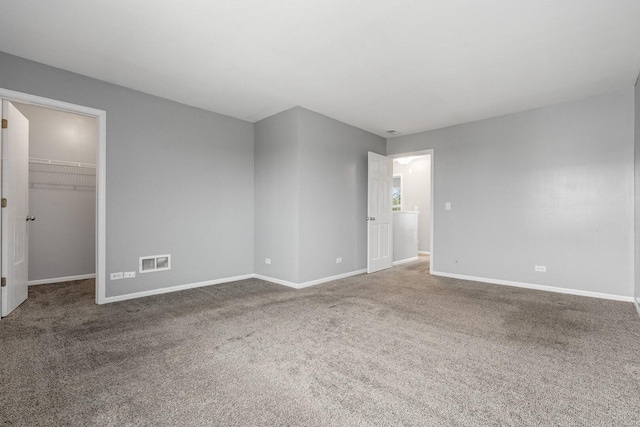 169 Waterbury Cir, Oswego, IL 60543 - unfurnished room featuring baseboards, visible vents, and carpet