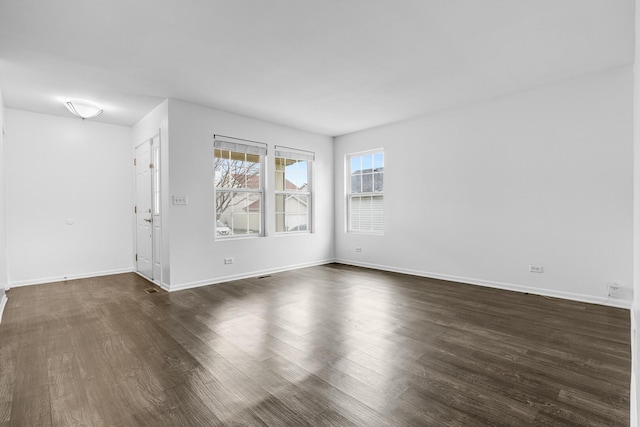 169 Waterbury Cir, Oswego, IL 60543 - empty room featuring dark wood finished floors and baseboards