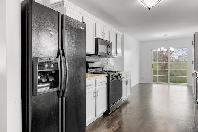 169 Waterbury Cir, Oswego, IL 60543 - kitchen featuring dark wood-type flooring, black appliances, a chandelier, tasteful backsplash, and white cabinetry