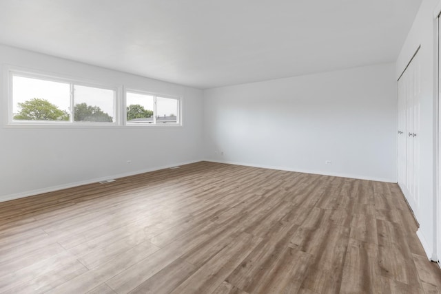 1062 Matfield Ct Unit 1062, Schaumburg, IL 60193 - unfurnished bedroom featuring wood finished floors, a closet, and baseboards