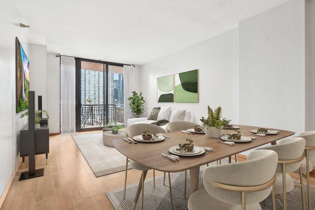 dining space with light wood-style floors and expansive windows