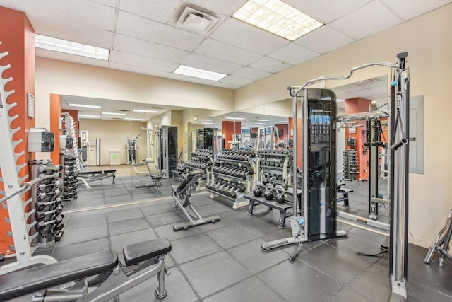 gym featuring visible vents and a paneled ceiling
