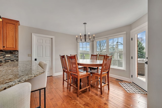 5255 Crescent Green Ct, Morris, IL 60450 - dining room featuring baseboards, an inviting chandelier, and light wood-style flooring
