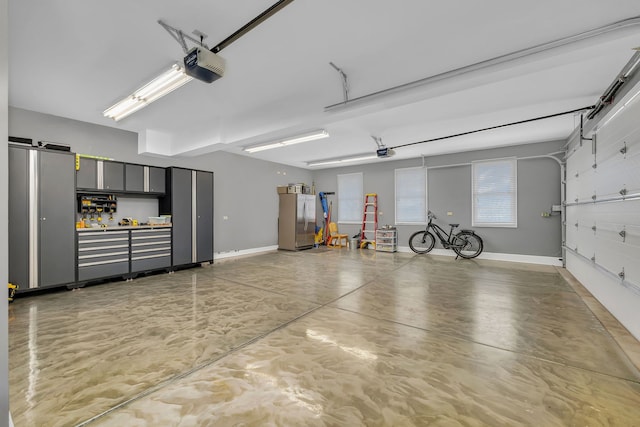 5255 Crescent Green Ct, Morris, IL 60450 - garage featuring freestanding refrigerator, baseboards, and a garage door opener