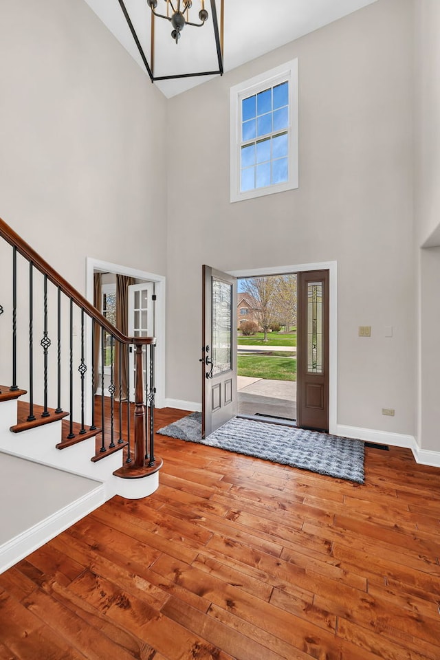 5255 Crescent Green Ct, Morris, IL 60450 - foyer entrance with stairway, hardwood / wood-style floors, a chandelier, baseboards, and a high ceiling
