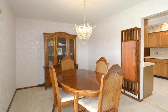 dining space with a chandelier, visible vents, baseboards, and light carpet