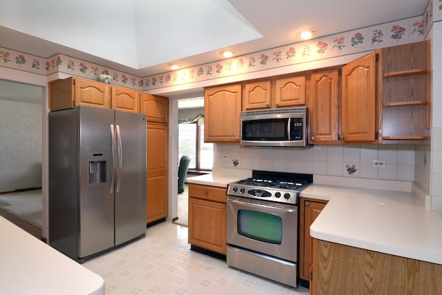 kitchen with open shelves, brown cabinetry, light countertops, backsplash, and appliances with stainless steel finishes