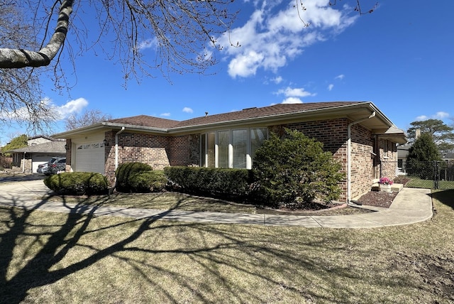 view of property exterior with brick siding, fence, and a garage