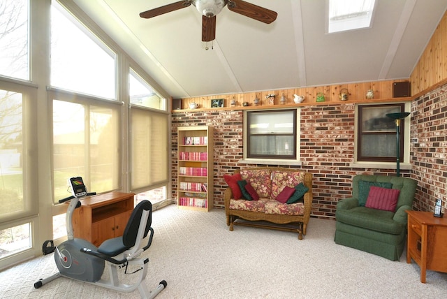 carpeted office space featuring wooden walls, plenty of natural light, and lofted ceiling