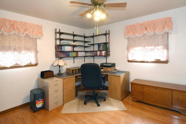 office space with light wood-style floors and ceiling fan