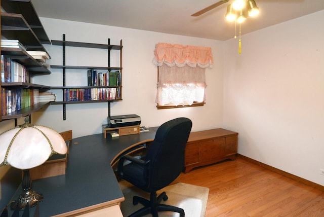 office space with wood finished floors, a ceiling fan, and baseboards