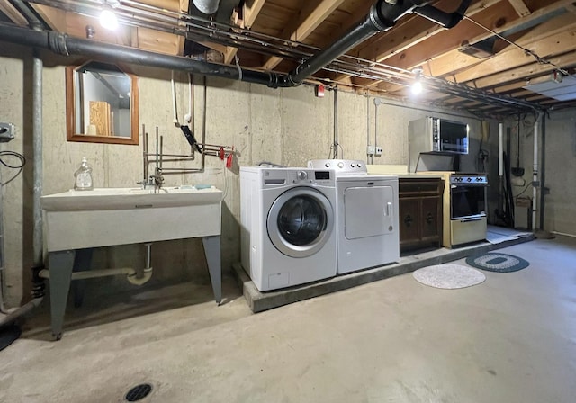 washroom featuring separate washer and dryer and laundry area