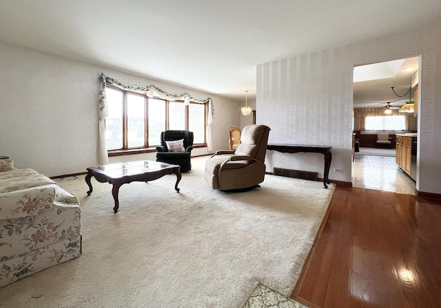 living area featuring light wood finished floors and baseboards