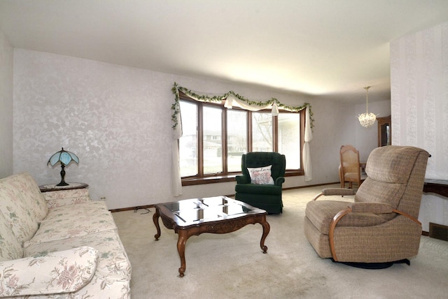 carpeted living area with baseboards and a notable chandelier
