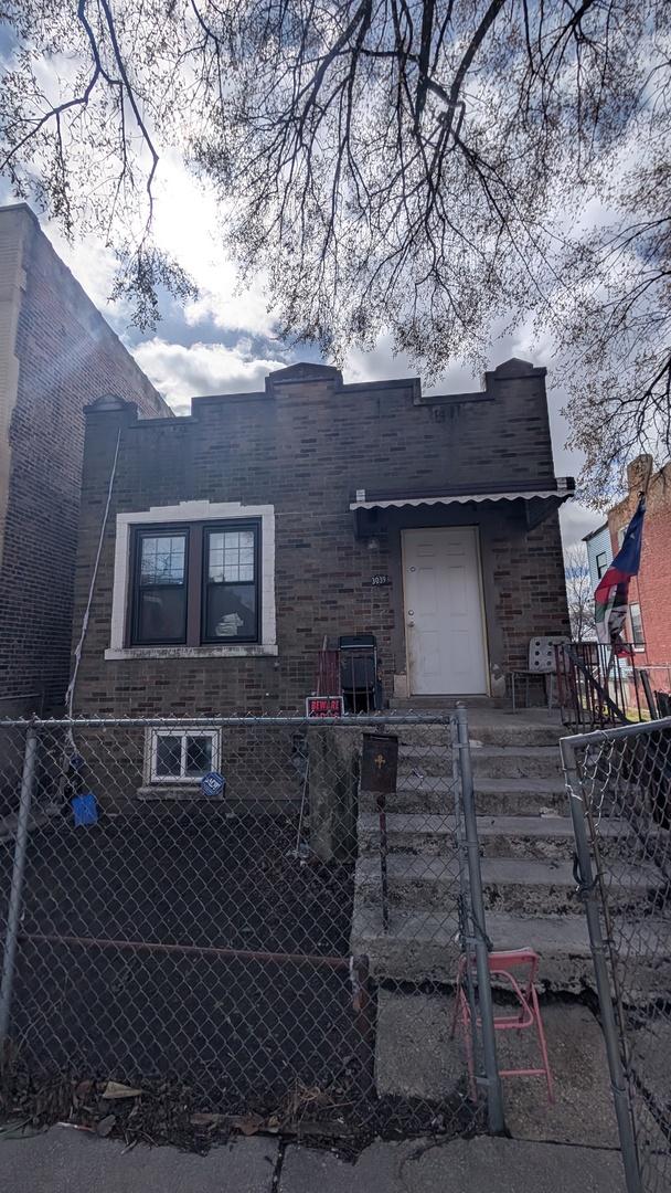 3039 W Flournoy St, Chicago, IL 60612 - view of front of property with brick siding and a fenced front yard