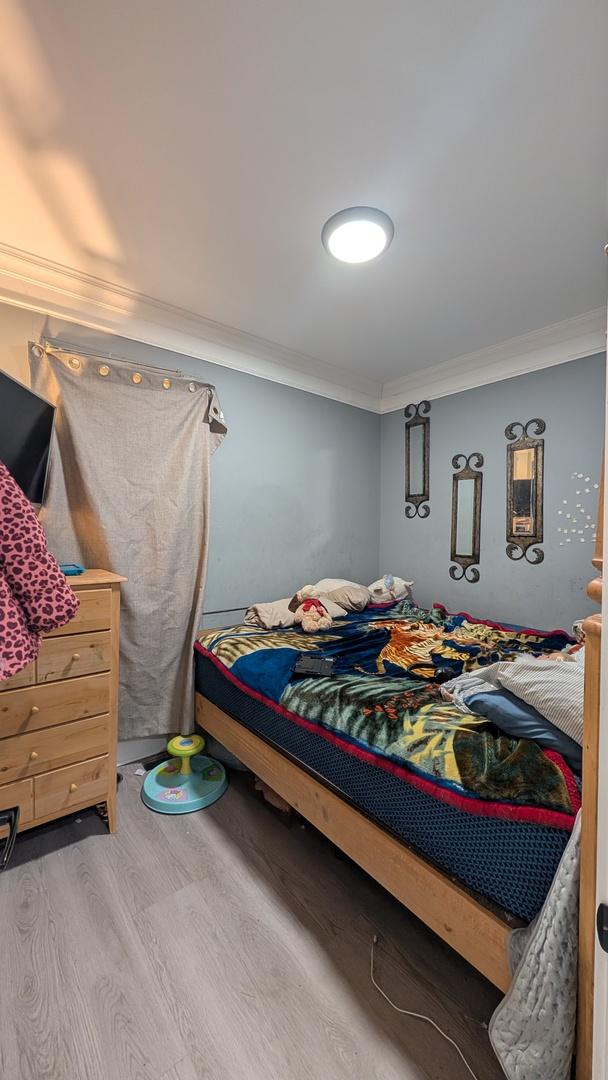 3039 W Flournoy St, Chicago, IL 60612 - bedroom featuring wood finished floors and crown molding