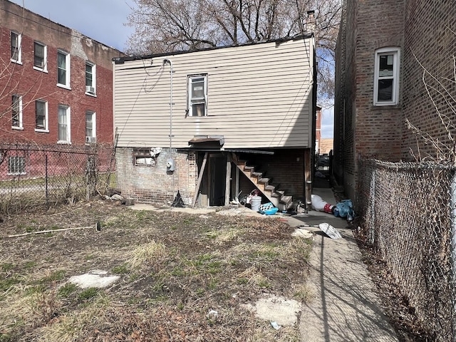 3039 W Flournoy St, Chicago, IL 60612 - rear view of property featuring a fenced backyard and stairway