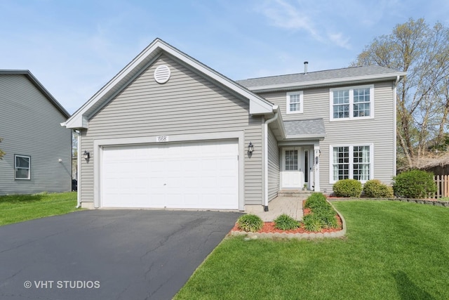 traditional-style home with an attached garage, a front yard, and aphalt driveway