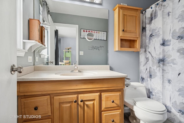 full bathroom with vanity, curtained shower, and toilet