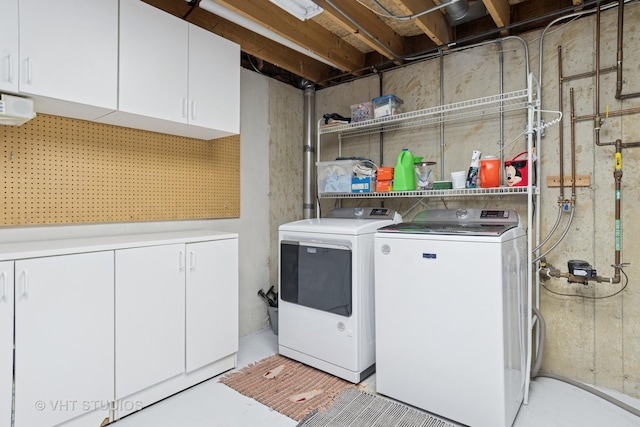 washroom with cabinet space and washing machine and clothes dryer