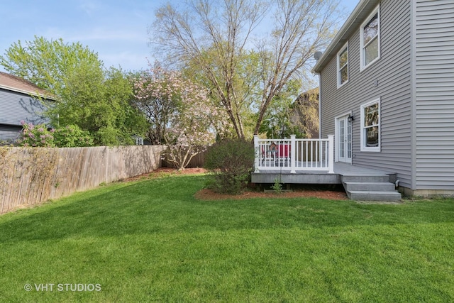 view of yard featuring a deck and fence