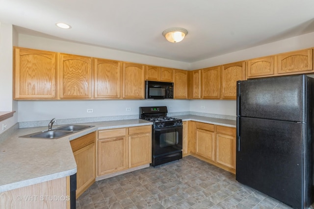 kitchen with light countertops, a sink, recessed lighting, and black appliances