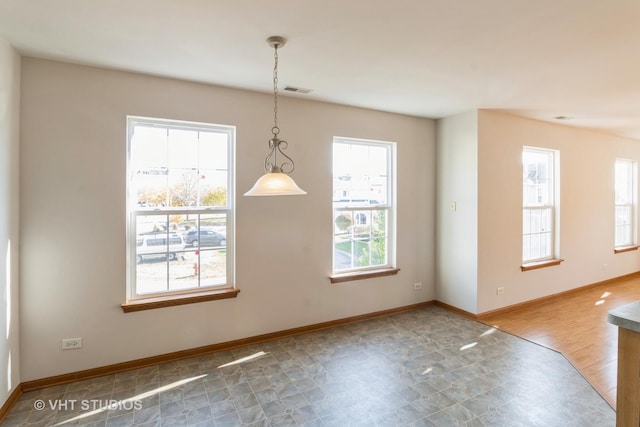 unfurnished dining area featuring visible vents and baseboards