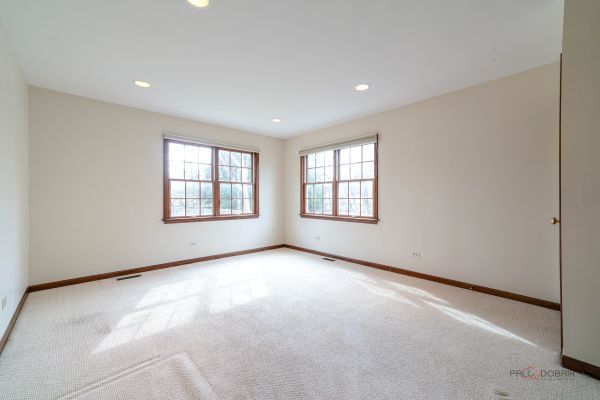 carpeted spare room featuring baseboards, visible vents, and recessed lighting