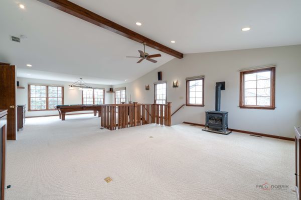 rec room featuring vaulted ceiling with beams, pool table, a wood stove, light colored carpet, and recessed lighting