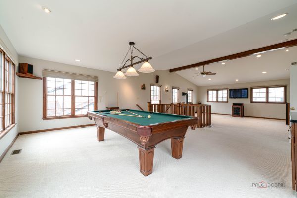 recreation room featuring light colored carpet, lofted ceiling with beams, baseboards, and billiards