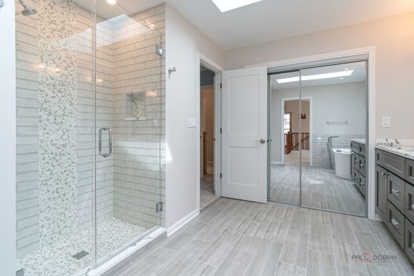 full bathroom with a shower stall, a soaking tub, vanity, and wood finished floors