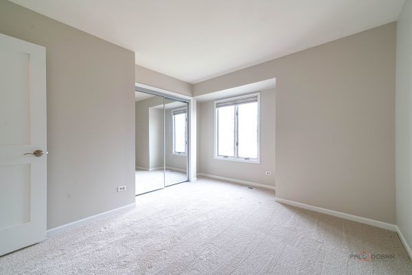unfurnished bedroom with baseboards, carpet flooring, and a closet