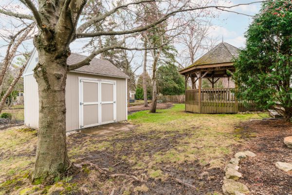 view of yard with a gazebo, a shed, and an outdoor structure