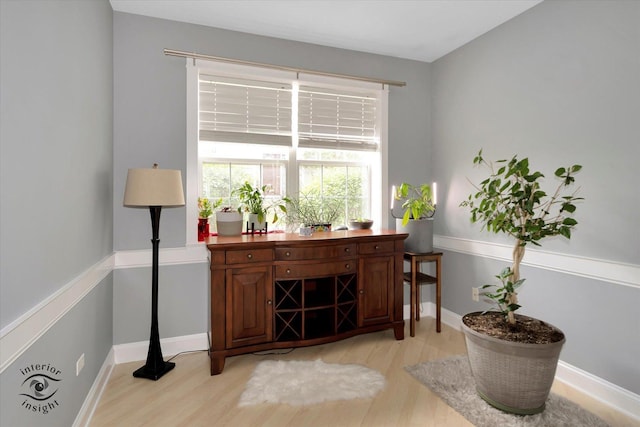 living area with light wood-style flooring and baseboards