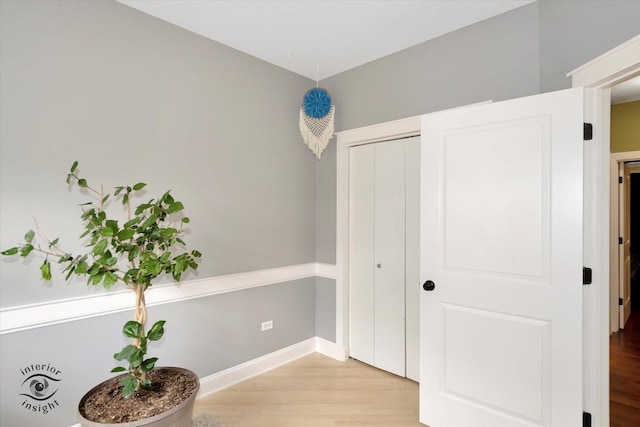 interior space with light wood finished floors and baseboards