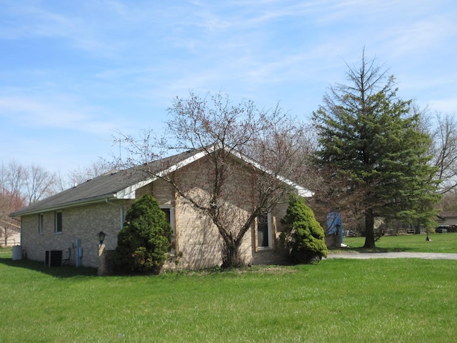 24541 S Wildwood Trl, Crete, IL 60417 - view of side of home featuring central AC and a yard