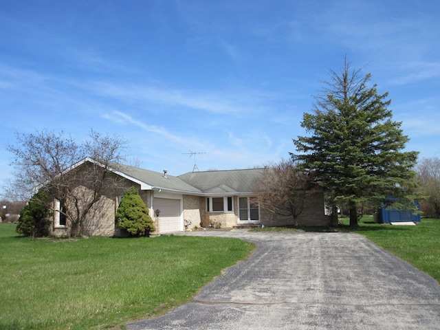 24541 S Wildwood Trl, Crete, IL 60417 - ranch-style home featuring aphalt driveway, a front yard, and a garage