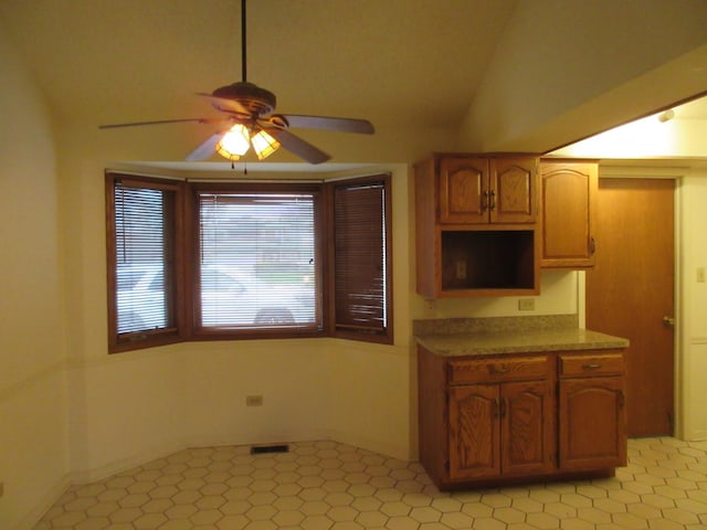 24541 S Wildwood Trl, Crete, IL 60417 - kitchen featuring brown cabinets, vaulted ceiling, and a ceiling fan