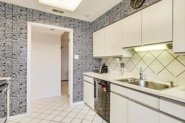 kitchen with light countertops, visible vents, a sink, light tile patterned floors, and black dishwasher