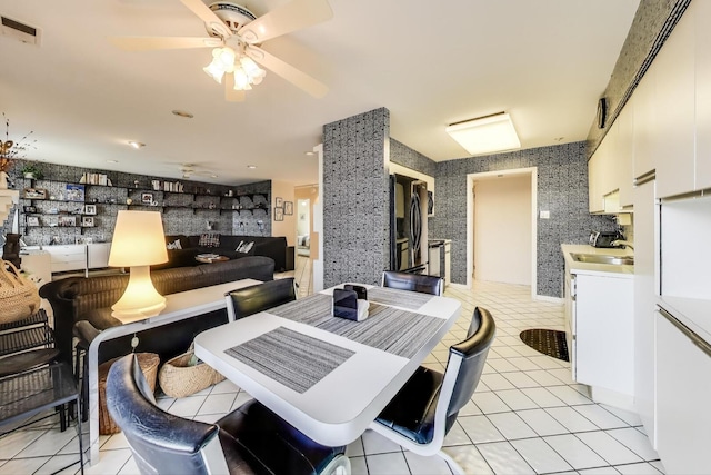 dining area featuring wallpapered walls, a ceiling fan, visible vents, and light tile patterned floors