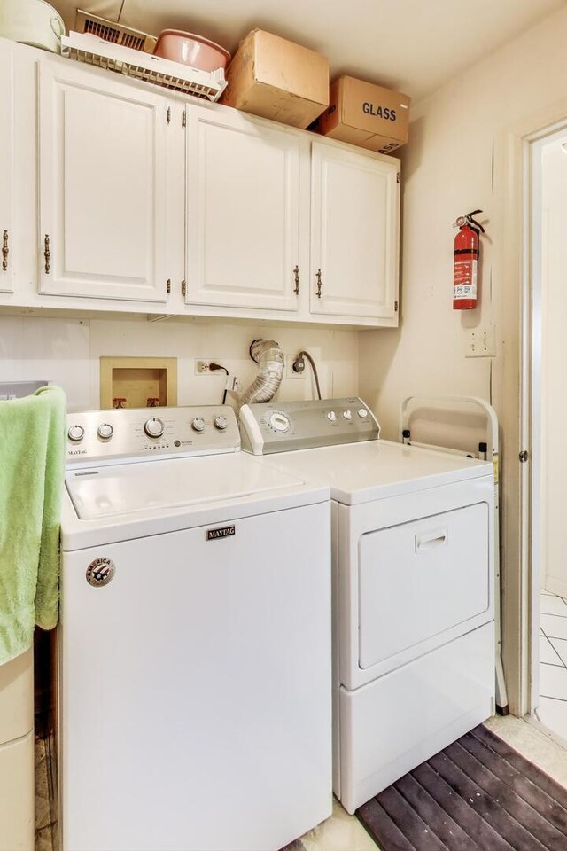 washroom with cabinet space and washing machine and clothes dryer