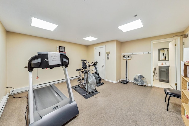 workout room with baseboards and carpet