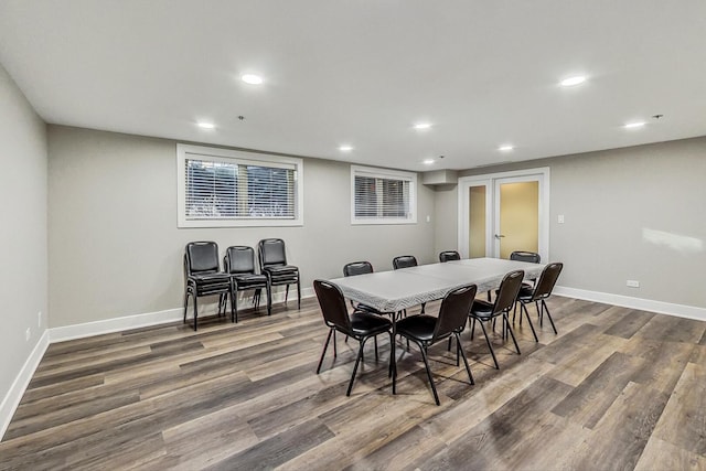 dining area featuring baseboards, wood finished floors, and recessed lighting