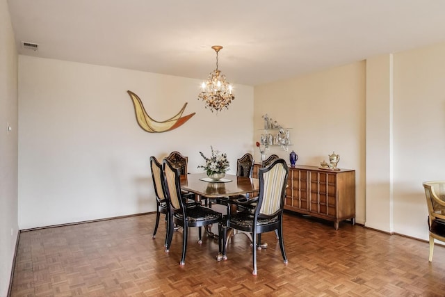 dining area with an inviting chandelier, visible vents, and baseboards