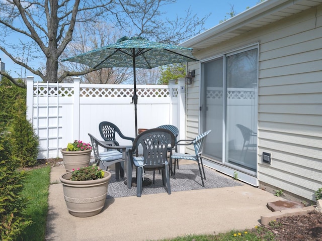 view of patio / terrace featuring fence and outdoor dining area
