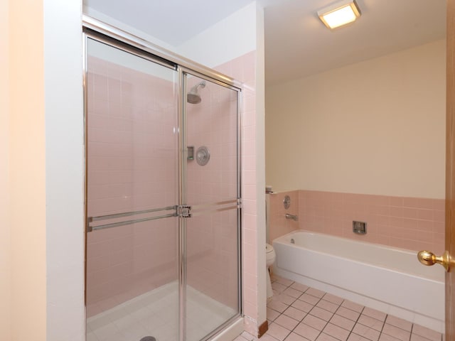 full bath featuring toilet, tile patterned floors, a shower stall, and a bath