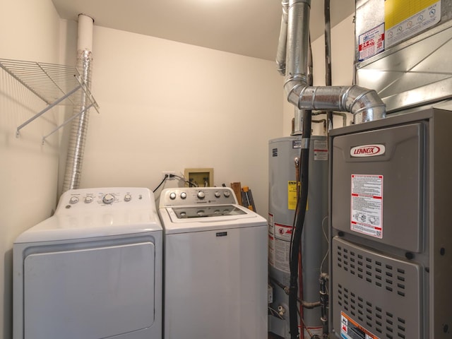 laundry area with gas water heater, laundry area, and independent washer and dryer